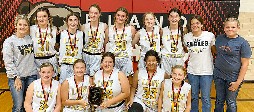 VMS’ LADY Eagles celebrate their Bland Lady Bear Basketball Tournament title by having a team picture taken with the championship plaque following their 26-24 come-from-behind victory over Salem’s Lady Tigers in Friday’s night championship game at Bland Middle School.